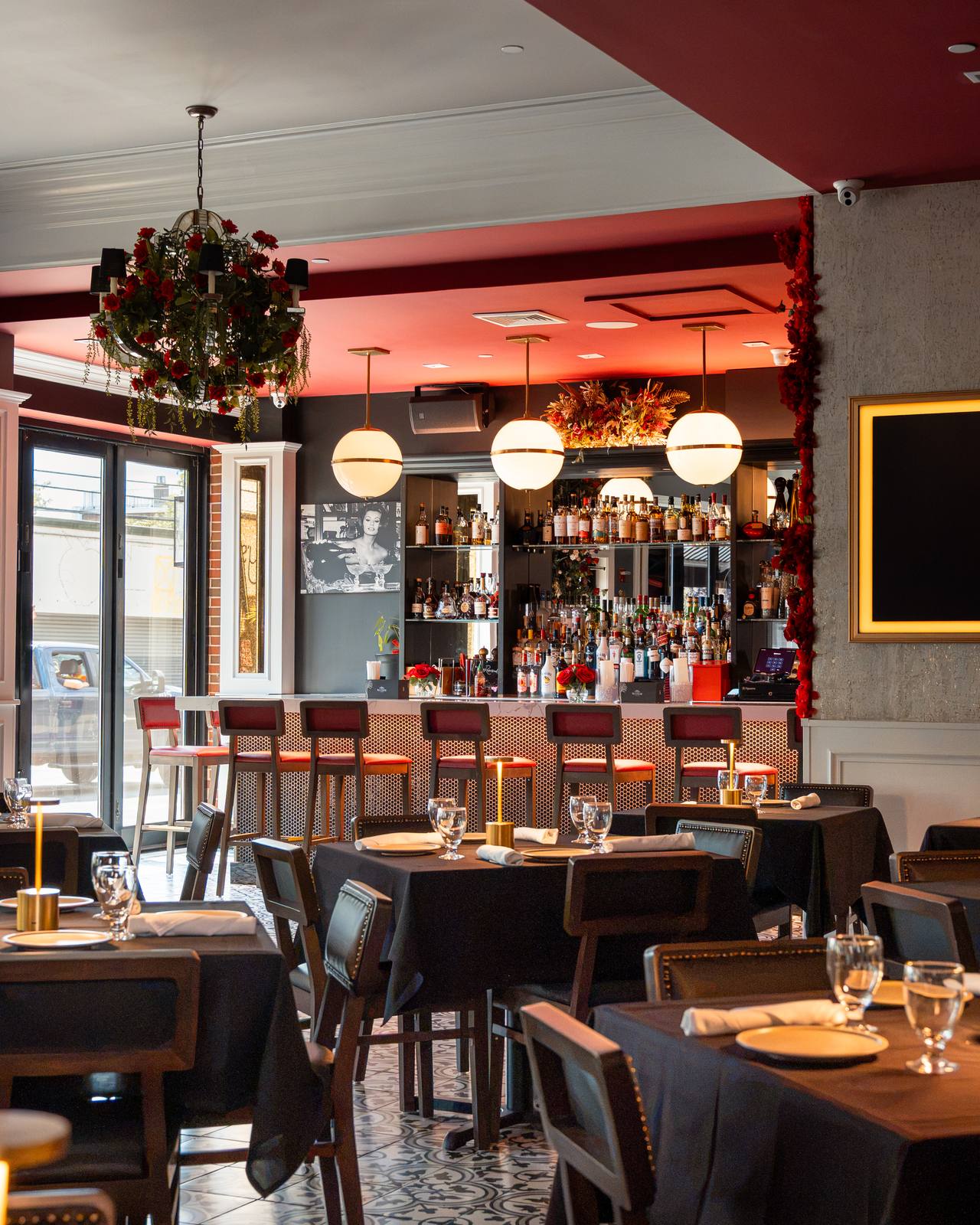 The main dining room at Baci with rose chandeliers and the marble bar