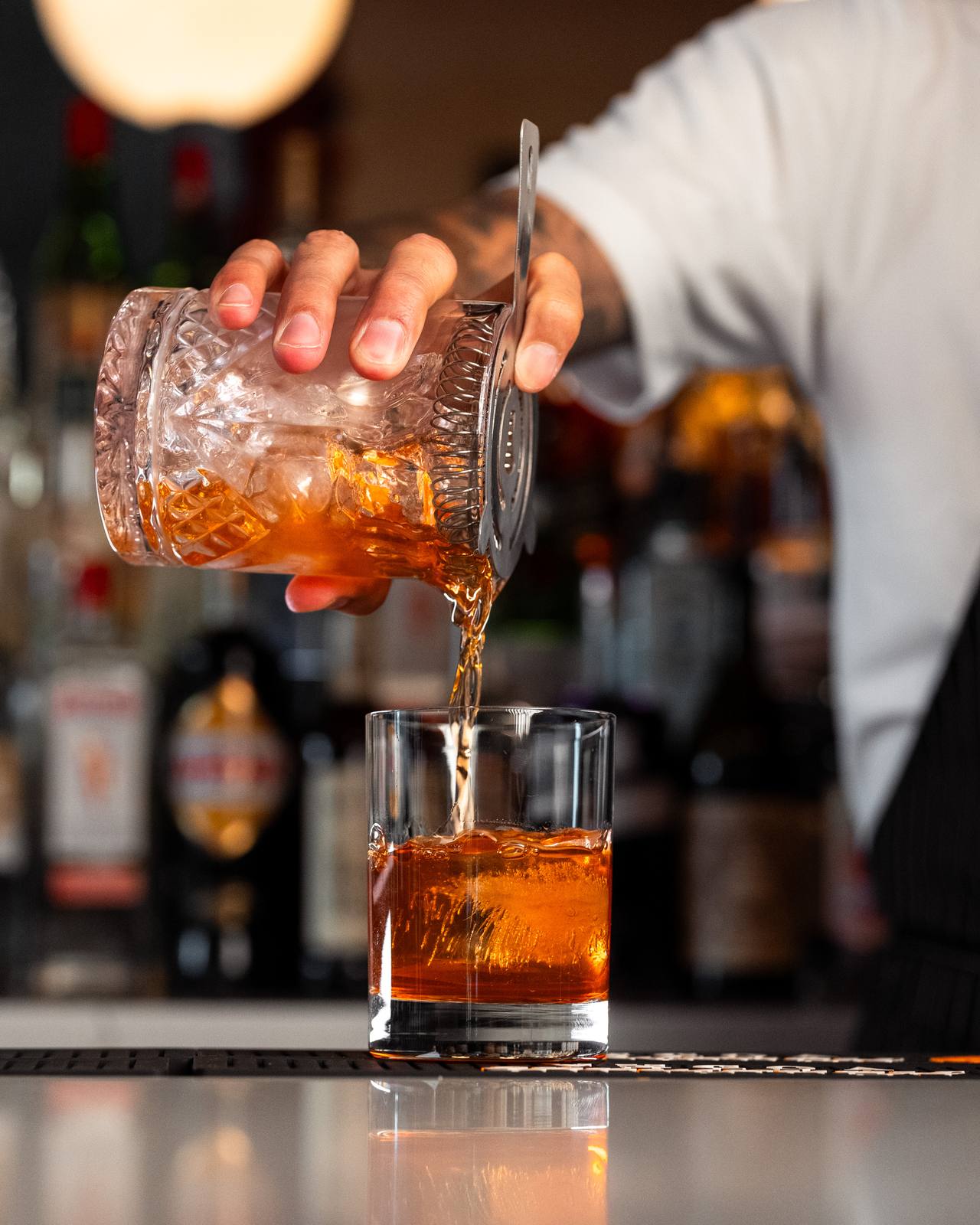 A negroni served over a hand-cut ice cube at the Baci bar