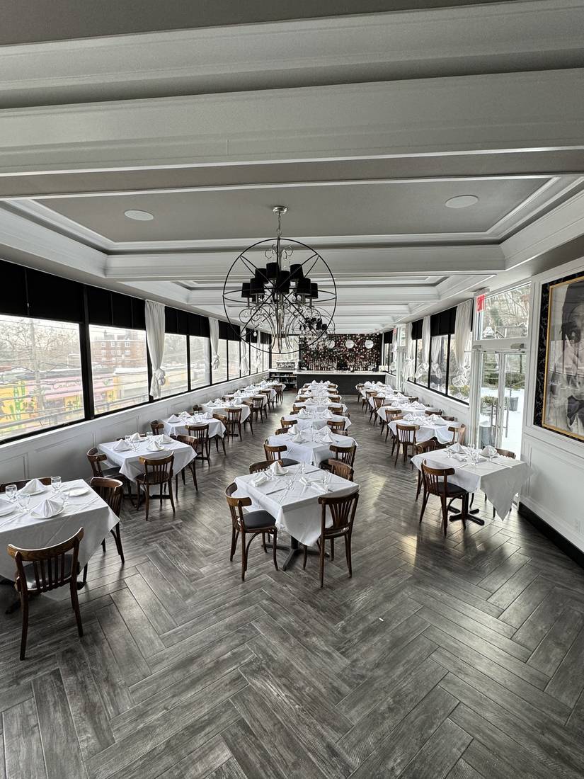 The Rooftop dining room with sculptural chandelier and herringbone floors
